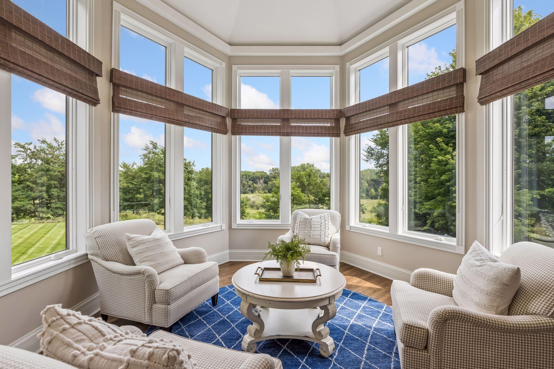 The four-season sun porch showcases breathtaking views of the beautifully tree-lined backyard.