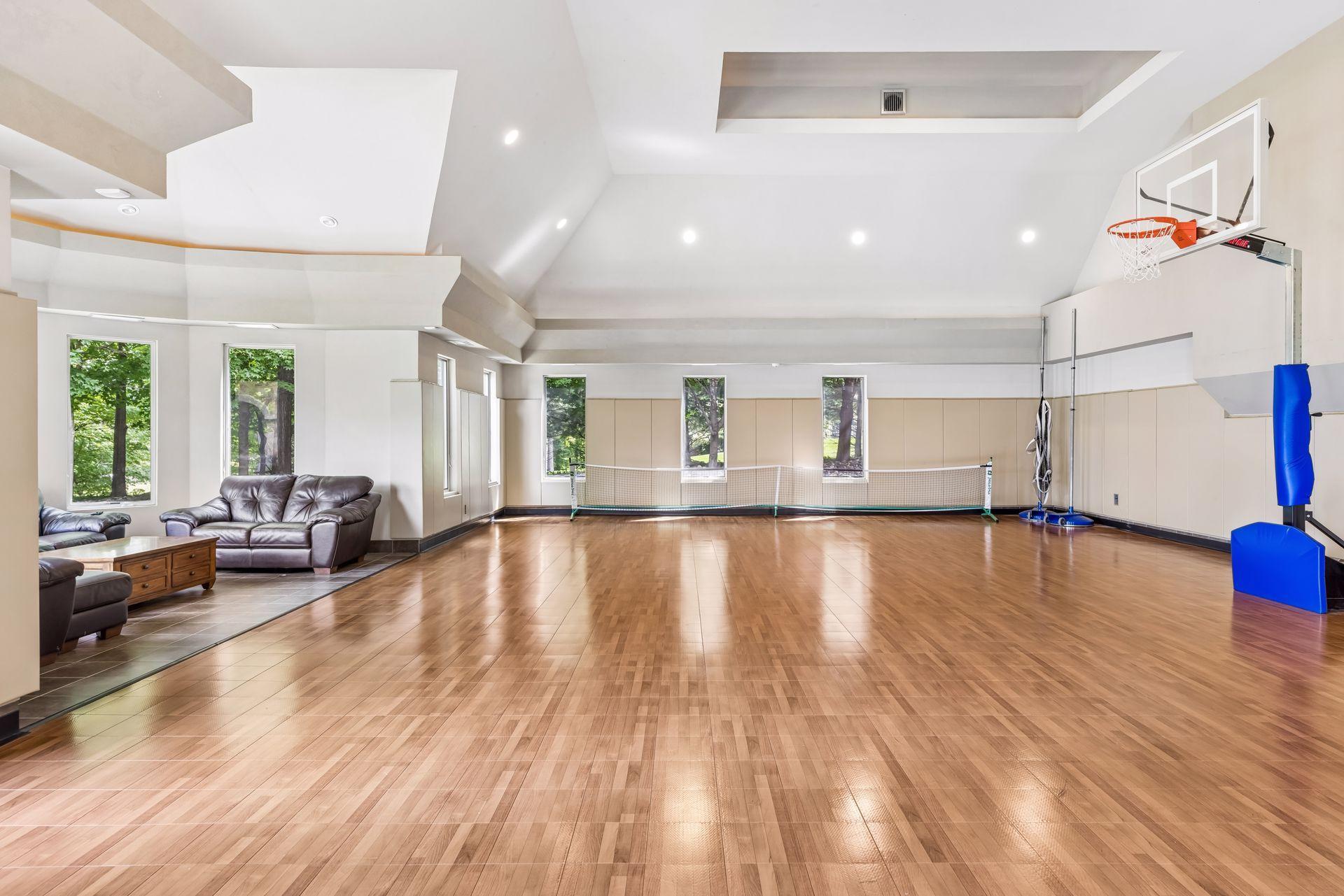The expansive sport court offers year-round use with its own furnace and is versatile enough for basketball, volleyball, pickleball, corn hole, and golf practice and can host events for 100+ guests