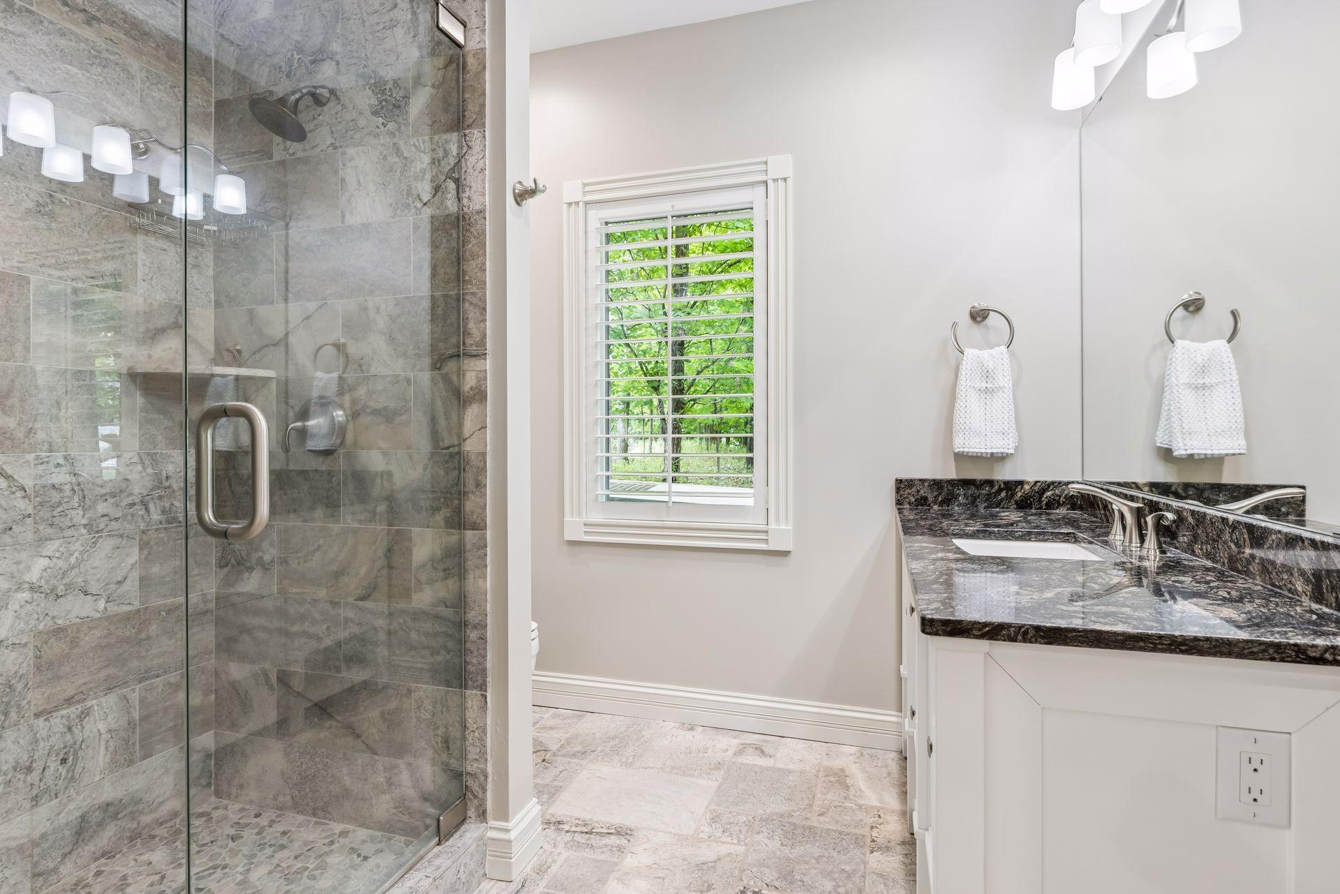 Bedroom 4 enjoys a private ensuite bathroom enhanced with an updated vanity and a beautifully tiled shower.