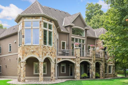 The expansive composite deck provides a beautiful vantage point over the homeâs private, tree-lined backyard.