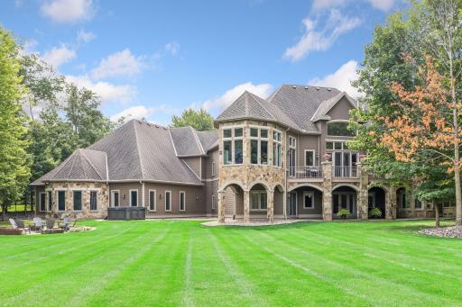 Generous patio spaces wrap around the back of the home, offering multiple areas to relax and entertain.