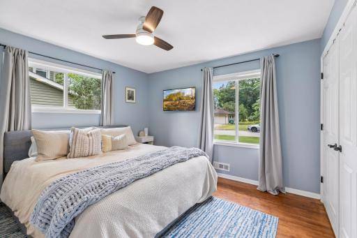 Serene space with hardwood floors and closet system