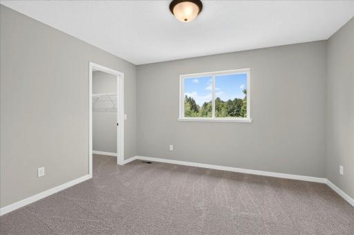 Bedroom 2. Photo taken of another home with similar plan and finishes.