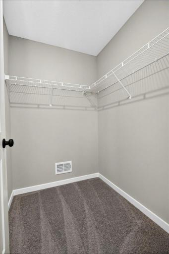 Primary Suite Walk In Closet. Photo taken of another home with similar plan and finishes.