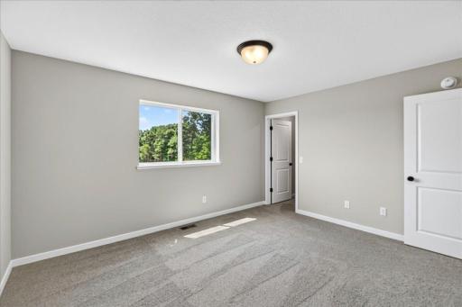 Primary Suite. Photo taken of another home with similar plan and finishes.
