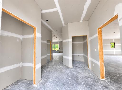 Main entry with coat closet to left and powder bath straight forward and attached garage to the right