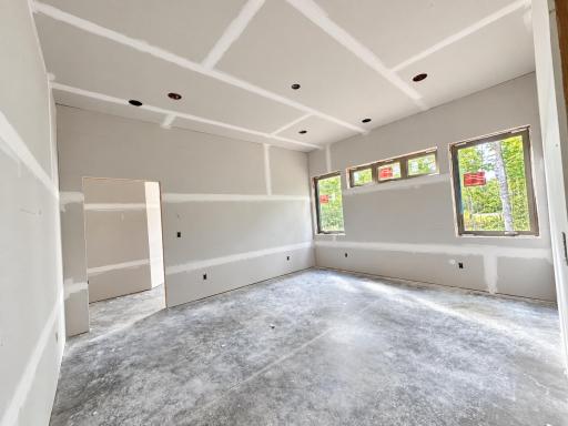 Primary bedroom on main floor with attached ensuite with laundry and large walk in closet.