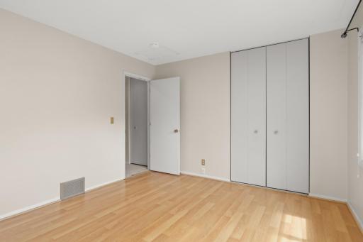 The primary bedroom features a large closet and newer laminate flooring.
