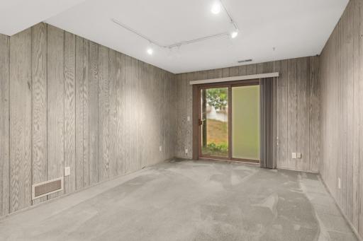 The walkout lower level features really cool wood paneling
