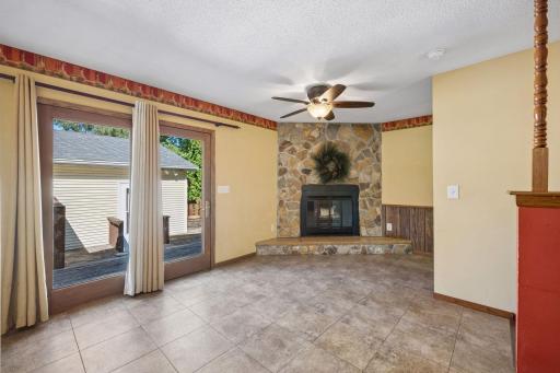 Entrance from back deck to family room with wood burning FP
