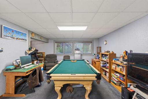 The lower level family room space is designed for fun and productivity, featuring plenty of room for a full size pool table and a dedicated desk area.
