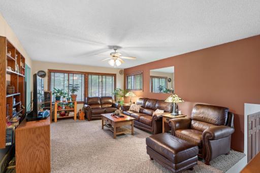 The spacious living room offers a comfortable gathering space with abundant natural sunlight and a warm, inviting atmosphere.