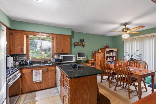 The kitchen features abundant cabinetry, generous counter space, and a practical layout that flows naturally into the adjacent dining area.