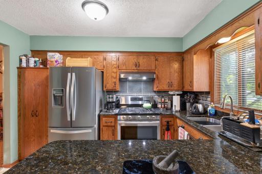 The kitchen features granite countertops, stainless steel appliances, and plenty of workspace for cooking and gathering with friends and family.