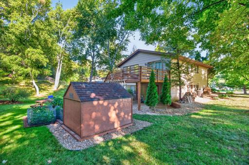 The backyard offers a wonderful blend of open green space and garden areas.