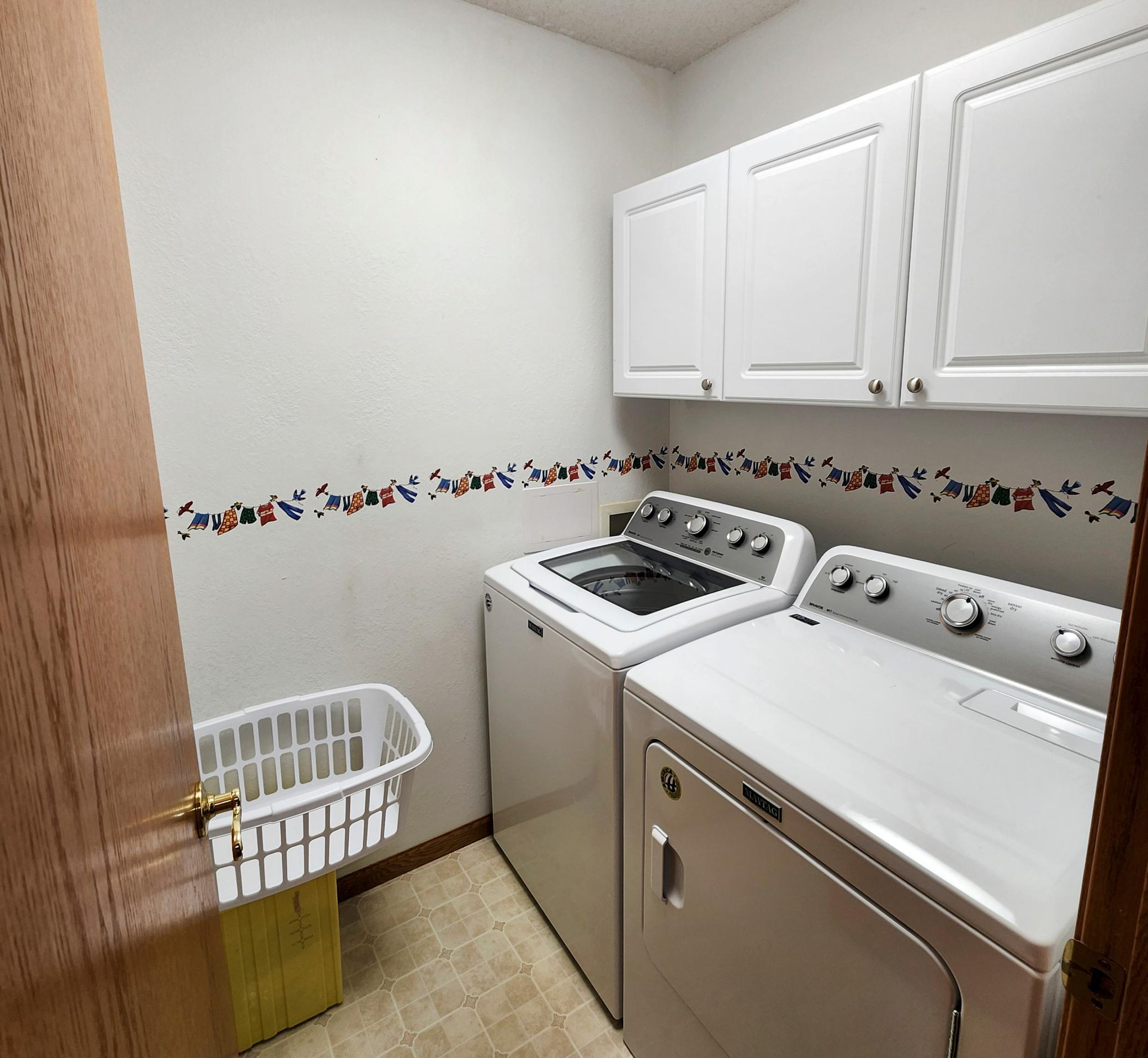 Separate Main Floor Laundry Room with Small Folding Counter behind the door