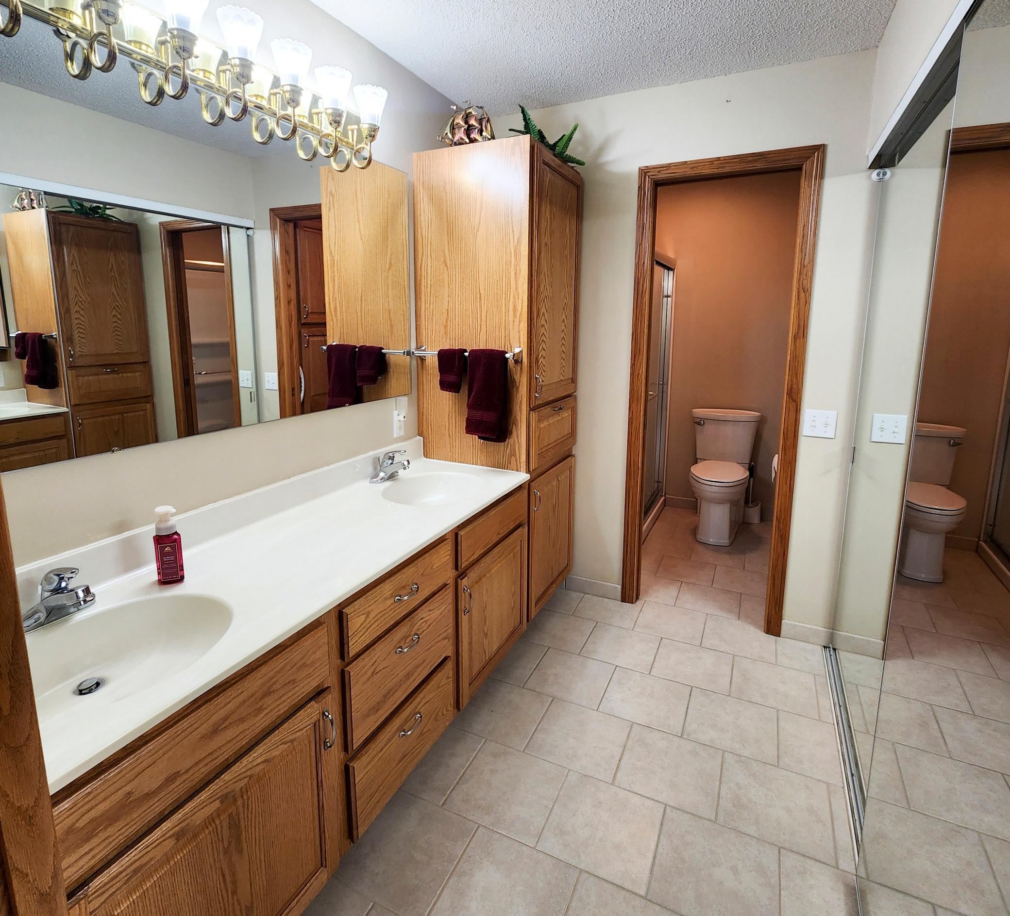 Double Sinks with Plenty of Storage in the Primary EnSuite Bathroom