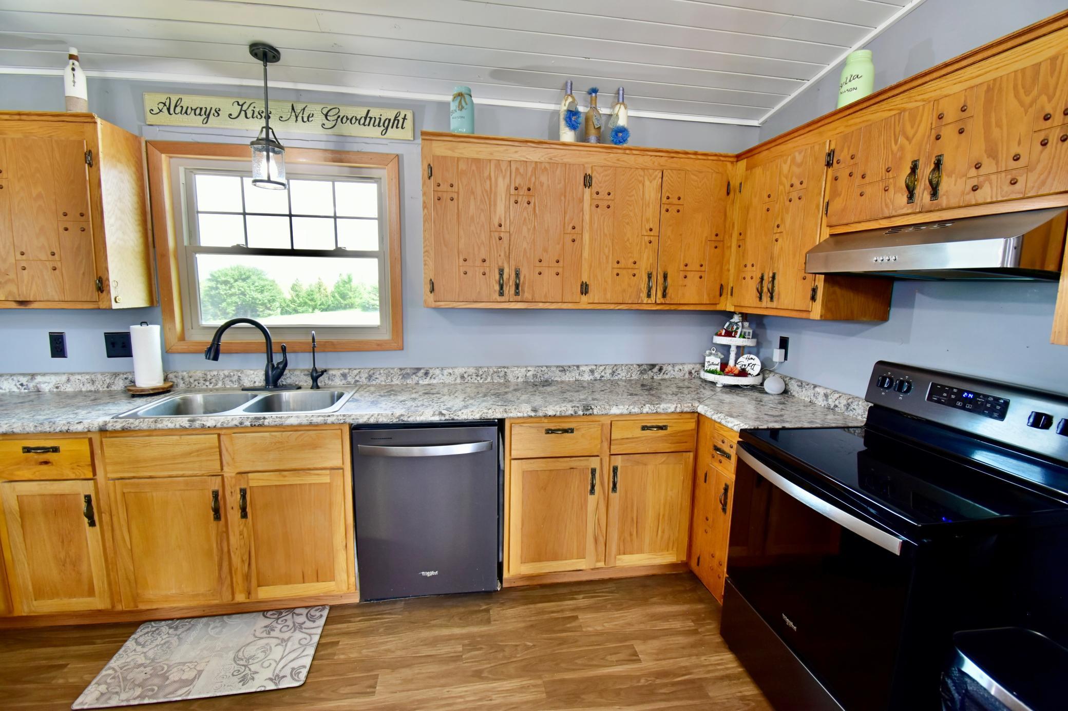 Beautifully updated kitchen area with plenty of cabinets and counter space - great for canning, meal prep and entertaining!