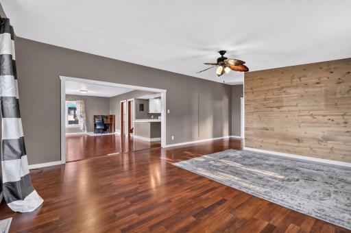 This view is from the SE corner of the living room peeking into the dining and kitchen.