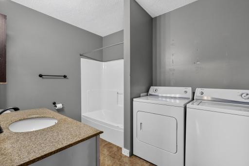 Updated main level full bathroom measures 8 x 10 and includes the washer/dryer.