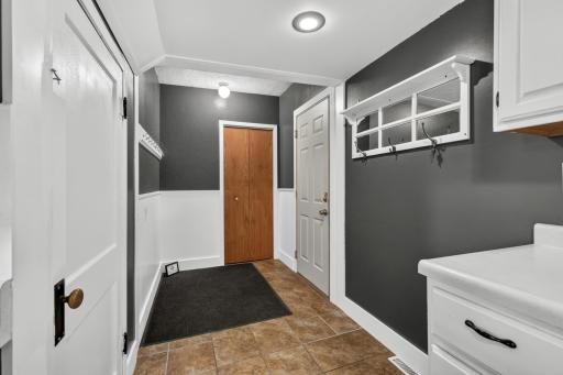 This is the entry coming in from the garage. Basement door to the left and brown closet with FA furnace