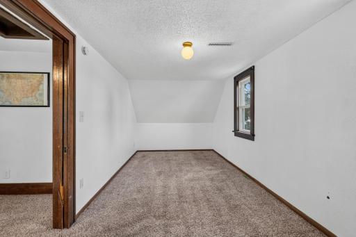 Upper level bedroom with window facing south.