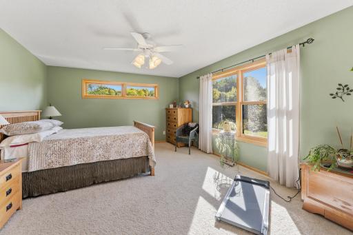 large primary bedroom with window overlooking yard