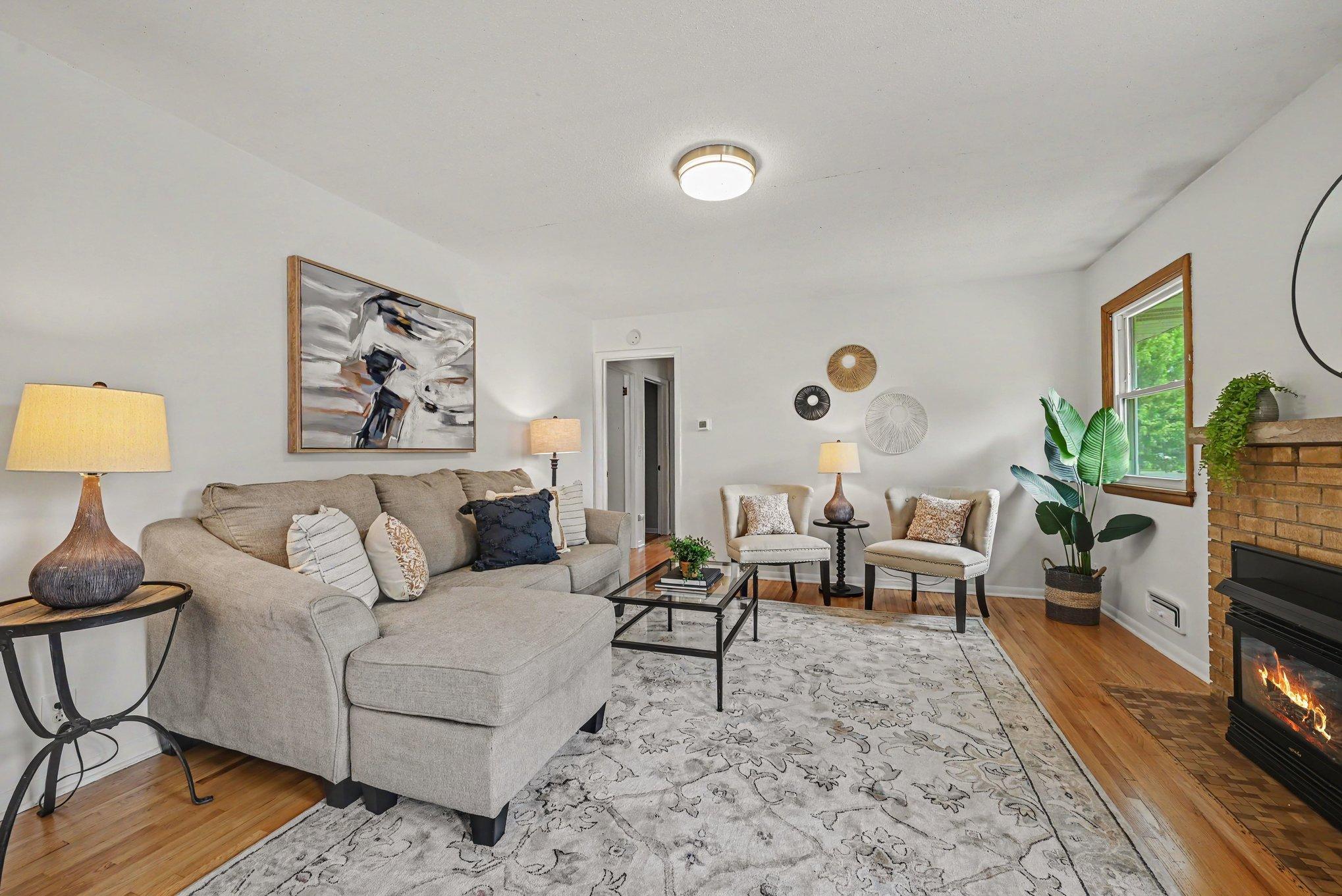 Living room with wood floors and gas burning fireplace