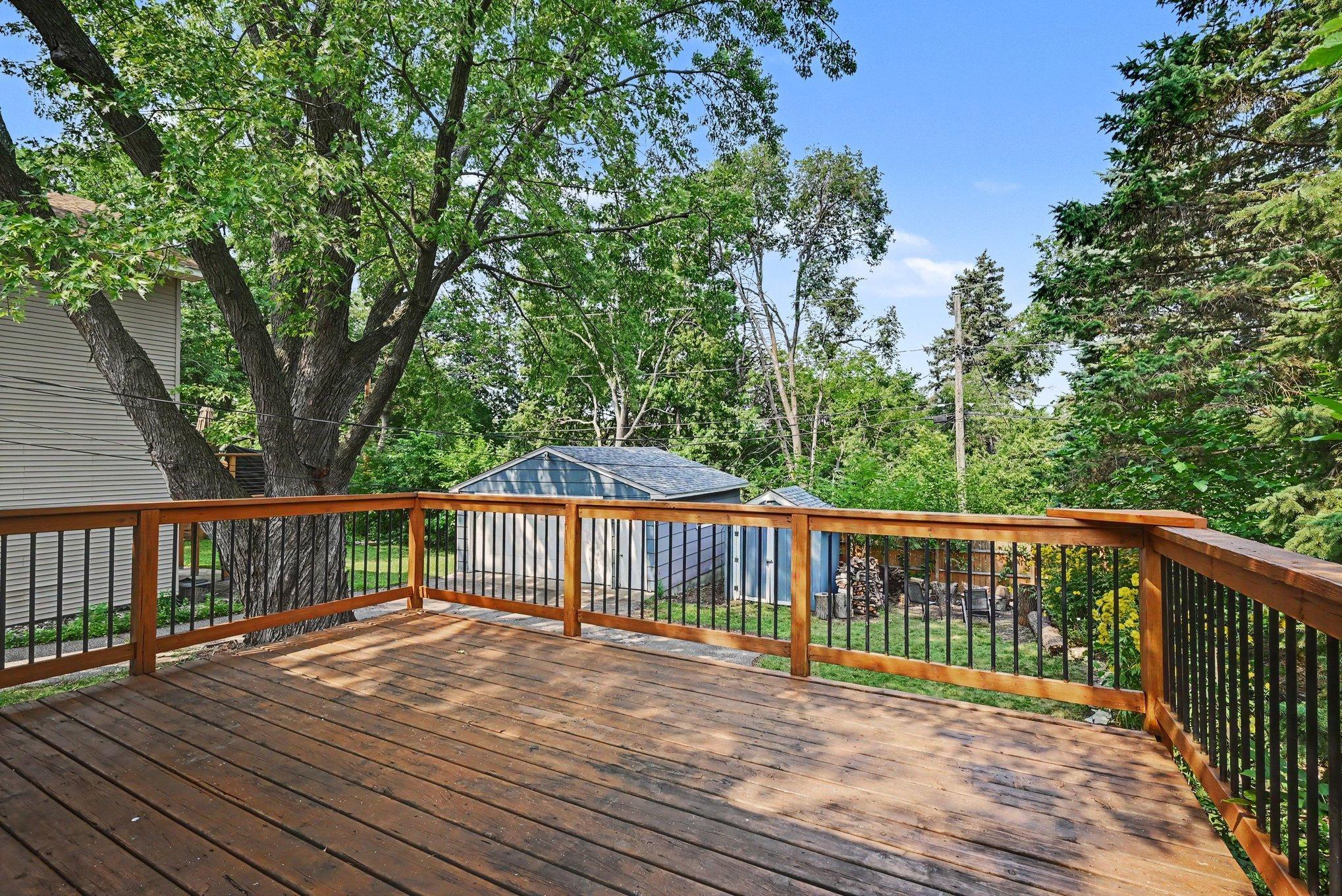 Spacious deck overlooking private backyard.