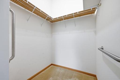 The primary suite includes a walk in closet with built in wire shelving for organized storage. Plenty of room here for a full wardrobe and more.