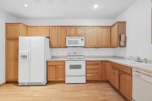 Side by side refrigerator and full appliance suite are included with this kitchen. Oak cabinetry extends floor to ceiling, offering exceptional storage options.