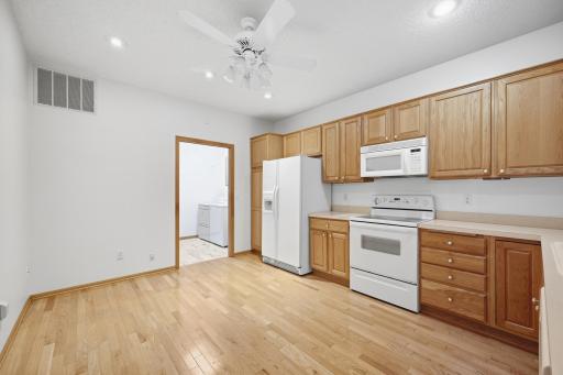 A vaulted ceiling with a stylish fan adds a bright, open feel to this well appointed kitchen. Full appliance package included makes this a truly move in ready space.