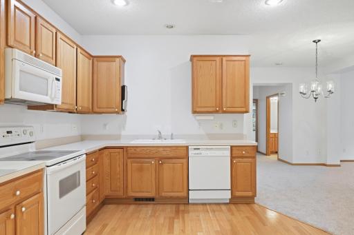 This corner captures the functional layout, with the sink positioned perfectly between the range and dishwasher. Just added new kitchen faucet. Neutral countertops complement the warm cabinetry throughout.
