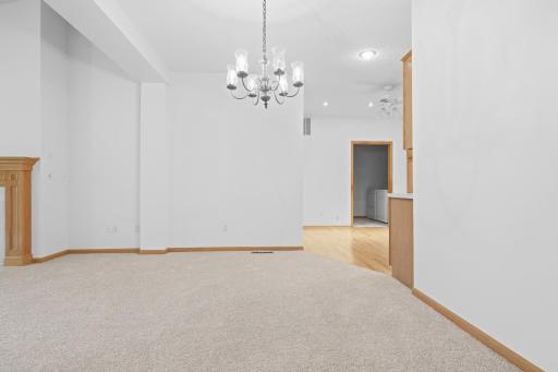Open concept flow connects the kitchen seamlessly to the adjoining dining and living New carpet throughout.