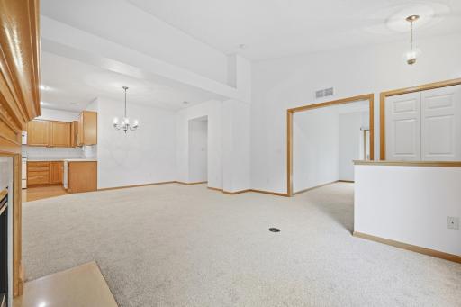 Fresh, new carpet in living room, dining area and hallway. French doors lead to an additional room off to the side, adding flexibility to the floor plan.