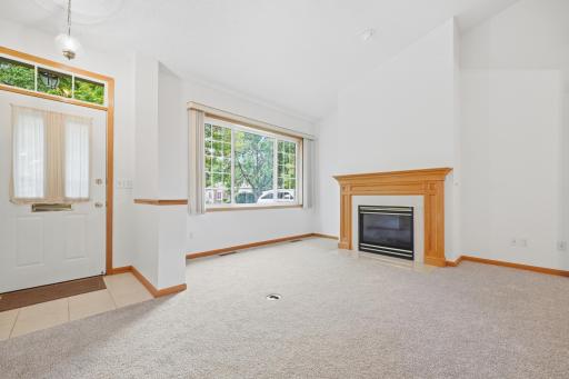 This living room offers a gas fireplace and a large picture window overlooking the front yard. The front entry is just steps away, creating an easy flow from the moment you walk in.