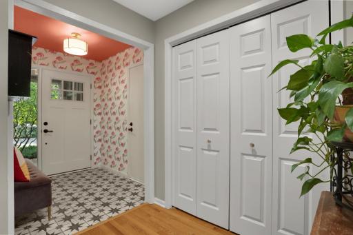 Beautiful front foyer with ceramic tile, a large closet and new hardwood 6 panel doors throughout the home