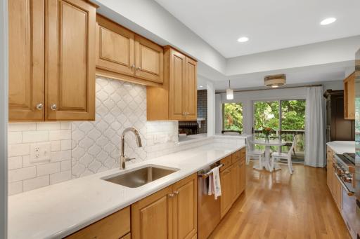 Lots of stunning quartz countertop space, beautiful tiled backsplash