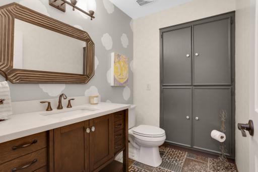 Main floor half bathroom with extra cupboards