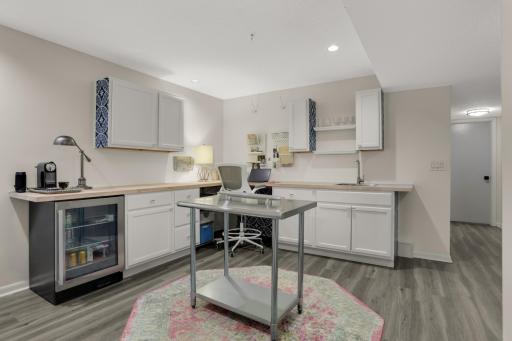 Lower level spacious and open office area with sink and beverage refrigerator and lots of work space