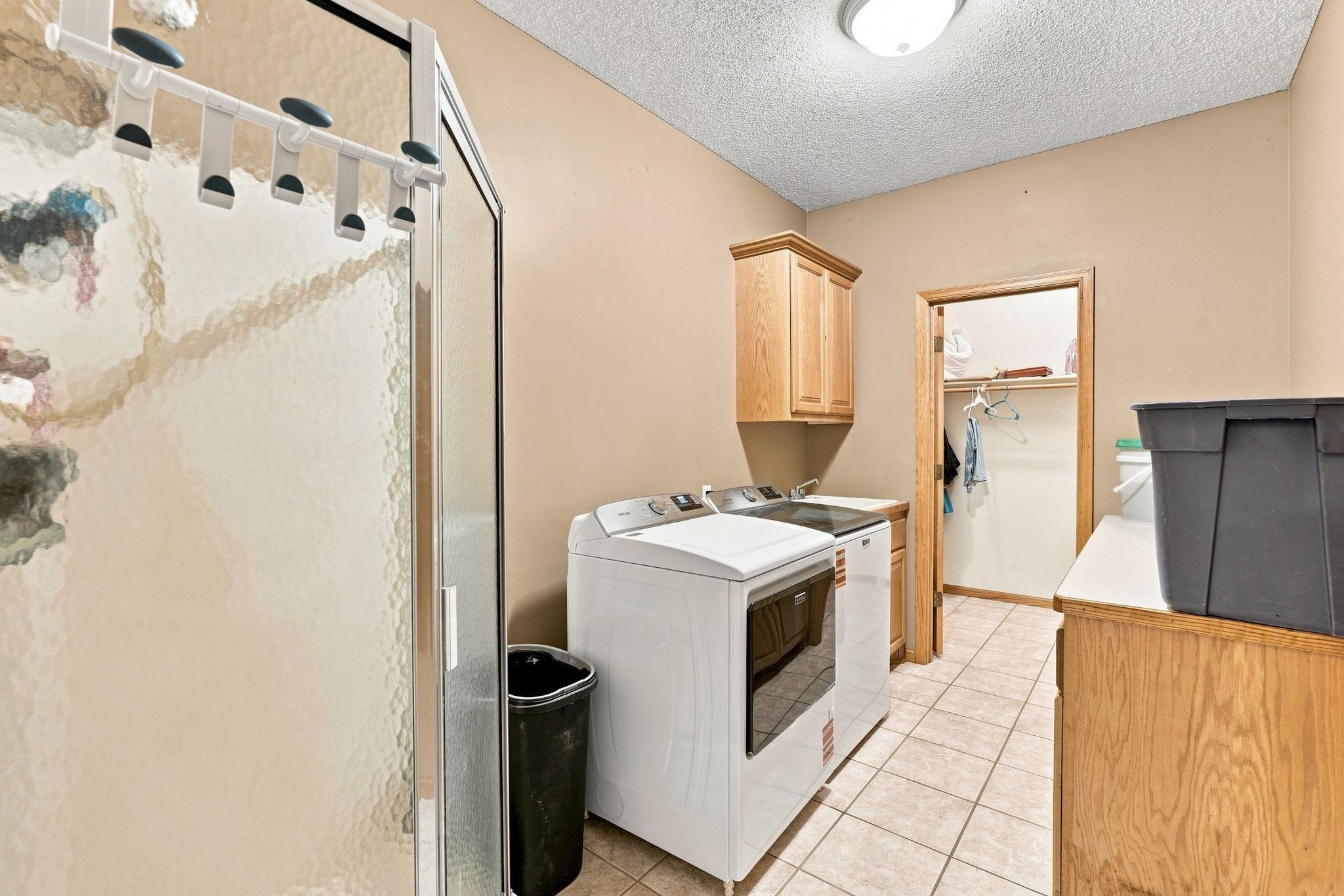 Laundry room off of the garage with plenty of counter space for folding and sorting clothes