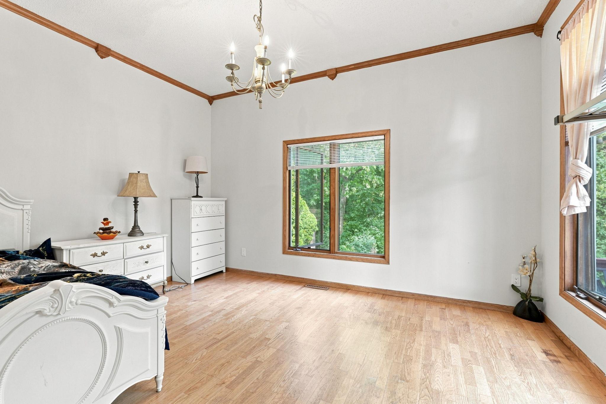 The well-lit dining room space (currently used as a bedroom) adjoins the kitchen