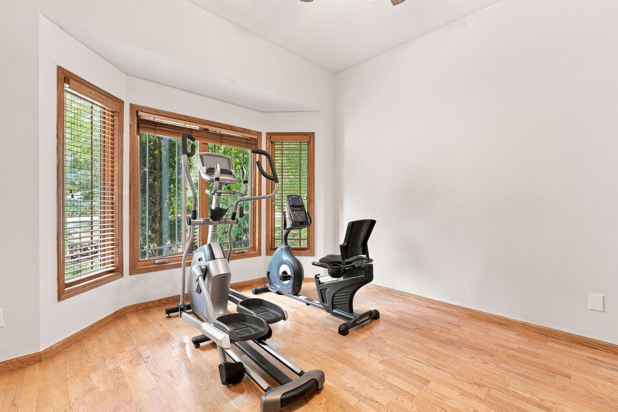 Another large space with hardwood floors and natural light sits off of the front entryway