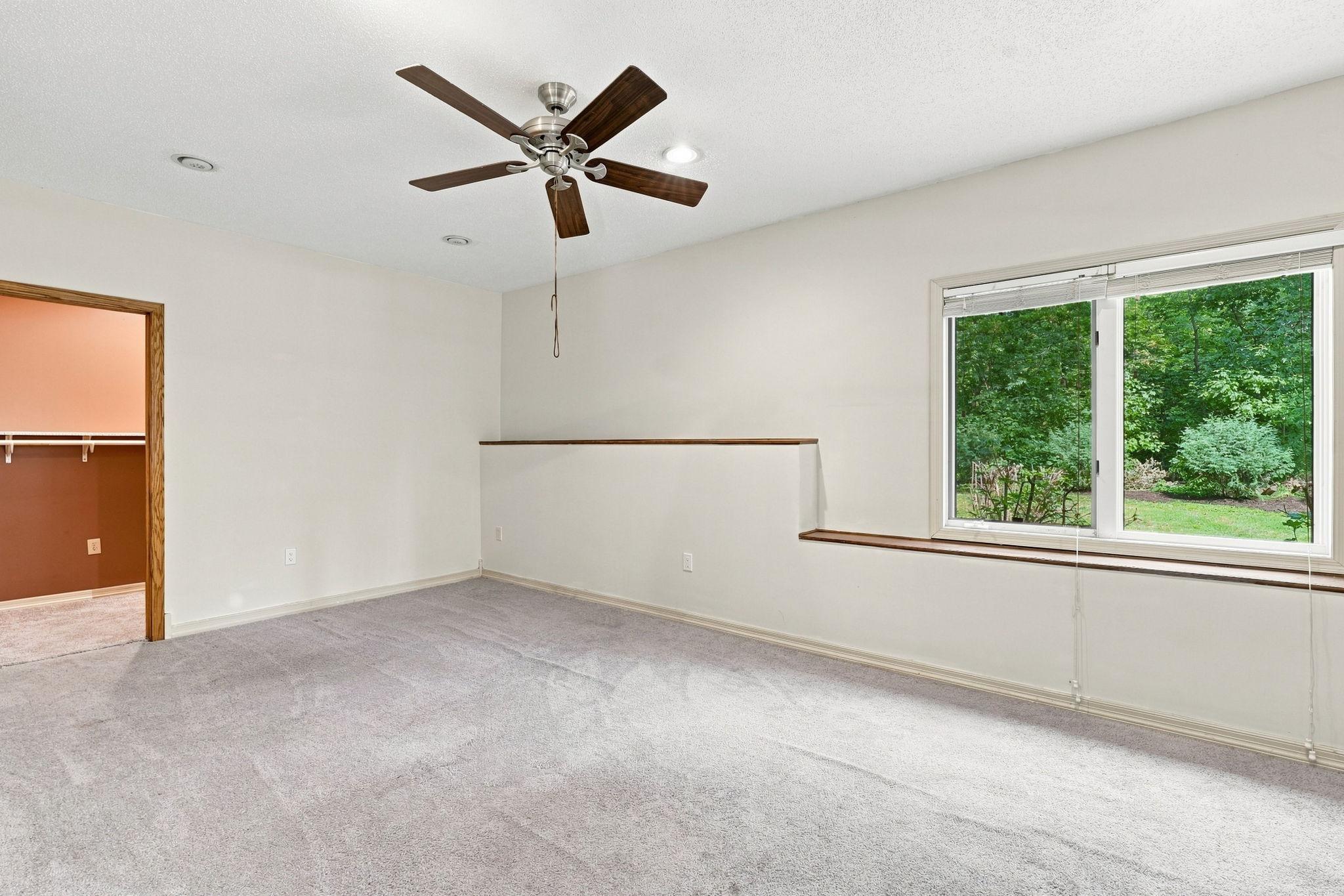 Lower-level bedroom featuring walk-in closet
