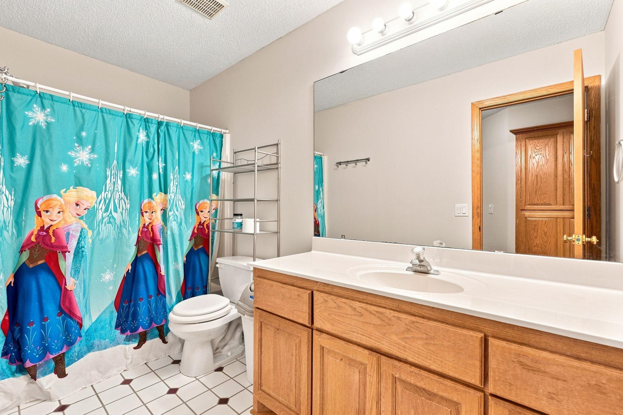 Upstairs bath with single vanity and shower/tub combo