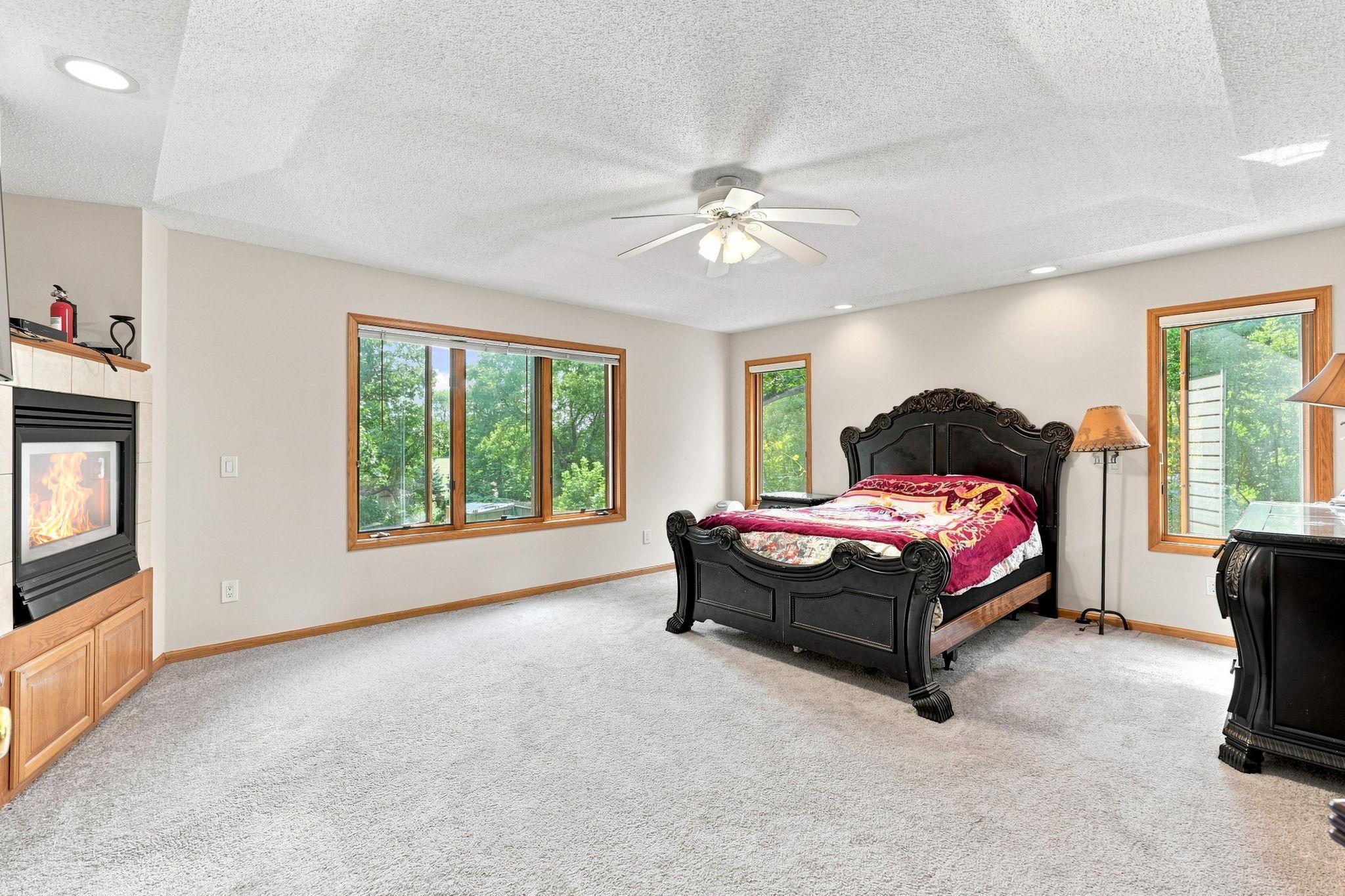 The primary suite features a fireplace and plenty of natural light