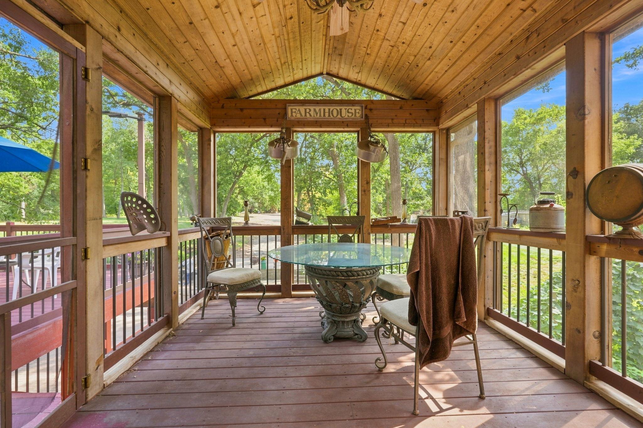 Inviting three-season porch with screened enclosure and deck access