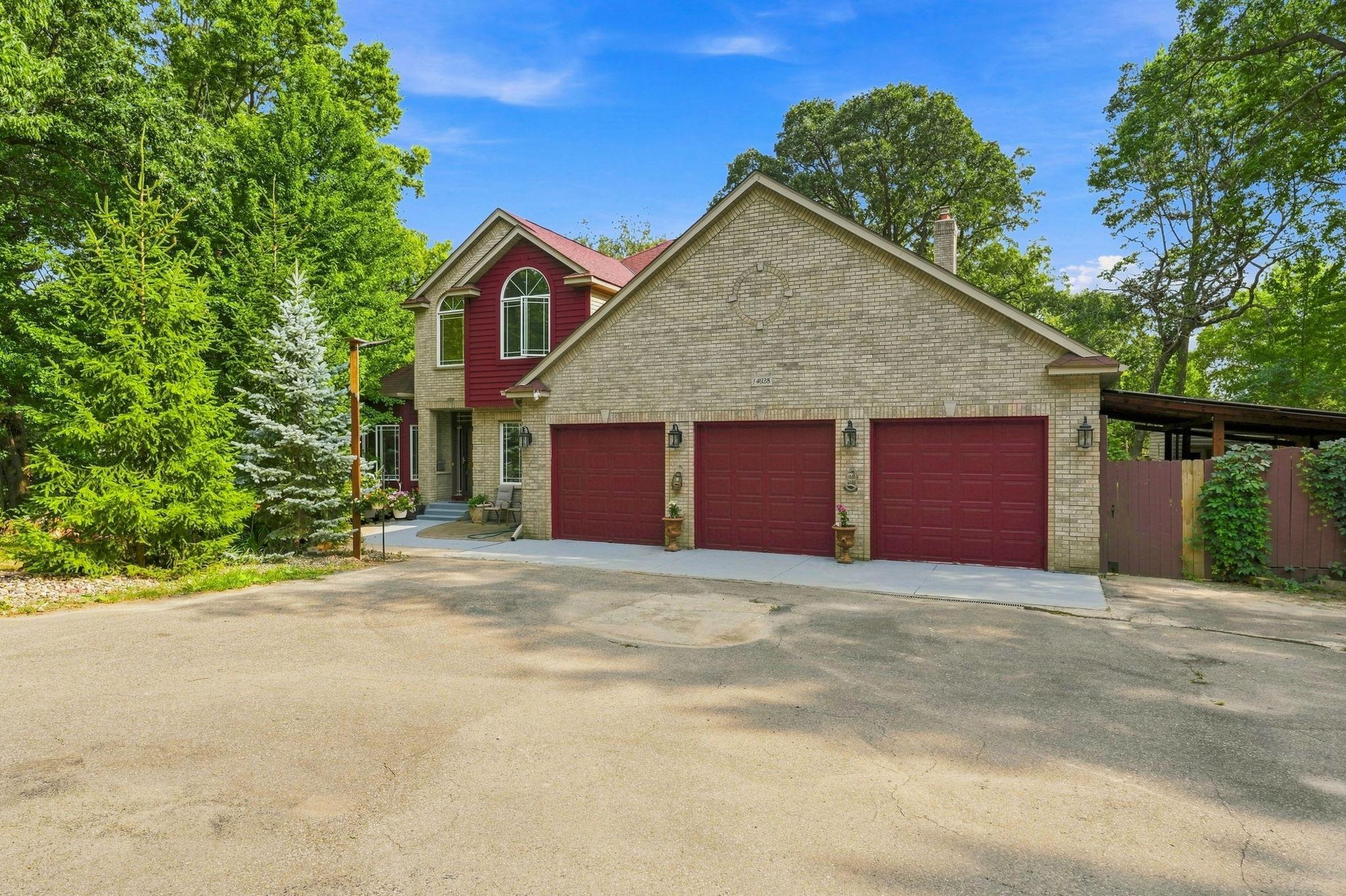 Peaceful wooded setting with ample driveway space and three-car garage