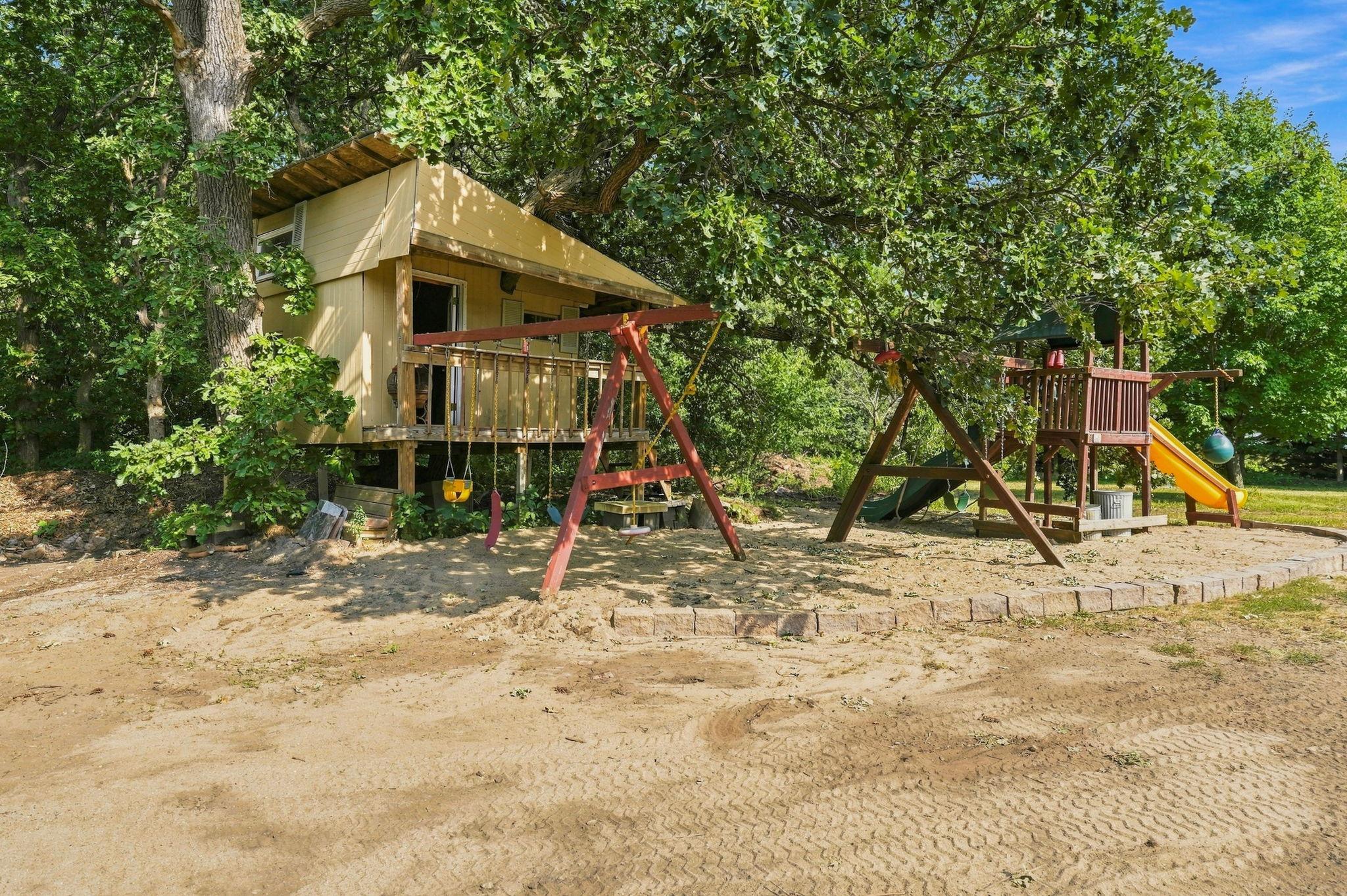 Custom playhouse and play area in the backyard