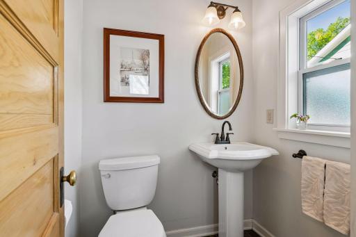Tasteful main floor powder room with heated tile floors.